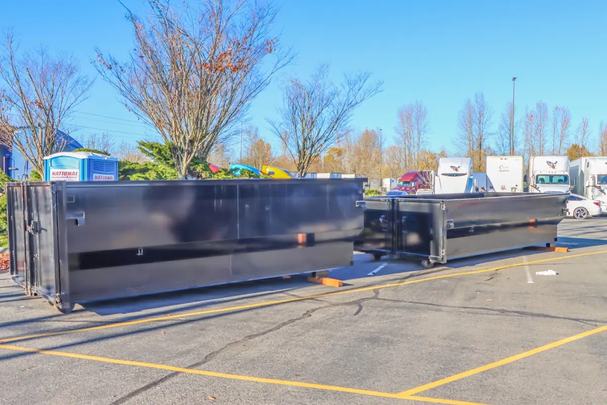 Professional dumpster rental service with roll-off container on residential driveway in Hobbs